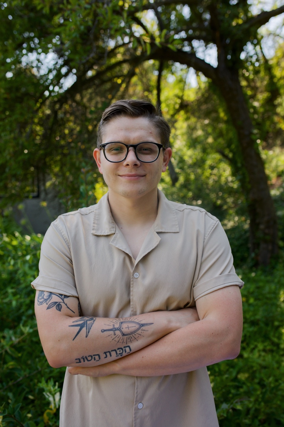 Evan Karwowski outdoors under a large tree